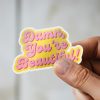 Man holding Damn You're Beautiful empowerment sticker