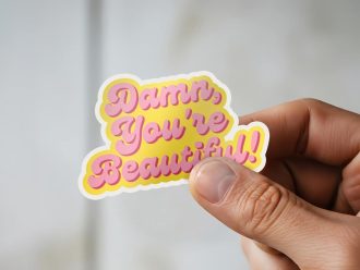 Man holding Damn You're Beautiful empowerment sticker