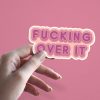 Woman holding Fucking Over It burnout sticker