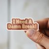 Man holding I Need A Damn Break self-care sticker