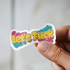 Man holding Let That Shit Go mental health sticker