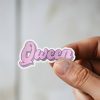 Man holding Qween pride rainbow sticker