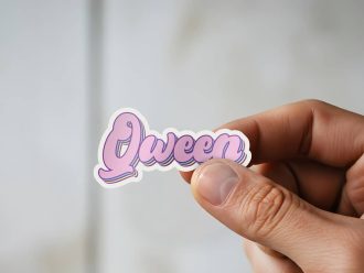 Man holding Qween pride rainbow sticker
